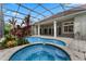 Inviting pool and spa area with a screened enclosure at 6533 Cartmel Ln, Windermere, FL 34786