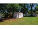 Exterior of a backyard shed with a picnic table, nestled under mature trees, adding storage and character to the property at 2812 Dawley Ave, Orlando, FL 32806