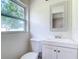 Bathroom features a modern vanity, mirror, and toilet near a window at 2812 Dawley Ave, Orlando, FL 32806