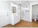 Modern bathroom with tiled shower, new vanity, and wood-look floors at 2812 Dawley Ave, Orlando, FL 32806