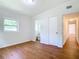 Bright bedroom with wood floors, ample space, and a doorway to the en-suite bathroom at 2812 Dawley Ave, Orlando, FL 32806