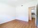 Bedroom with hardwood floors, neutral walls and connecting door to the kitchen at 2812 Dawley Ave, Orlando, FL 32806