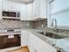 Close up of the kitchen featuring granite countertops, stainless steel appliances, and white cabinets at 2812 Dawley Ave, Orlando, FL 32806