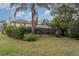 Landscaped backyard with large pool and screened enclosure at 105 James Pond Ct, Debary, FL 32713