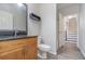 Bathroom with granite vanity, wood cabinets and a view of a staircase at 105 James Pond Ct, Debary, FL 32713