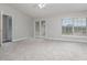 Bright bedroom with carpet flooring, ceiling fan, and access to a balcony at 105 James Pond Ct, Debary, FL 32713