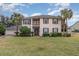 Two-story house with gray shutters, palm trees, and a well-manicured lawn at 105 James Pond Ct, Debary, FL 32713