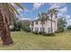 Two-story house with gray shutters, palm trees, and a large yard at 105 James Pond Ct, Debary, FL 32713