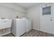 Laundry room with washer, dryer, utility sink, and ample shelving at 105 James Pond Ct, Debary, FL 32713