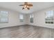 Spacious living room with wood-look floors and multiple windows at 105 James Pond Ct, Debary, FL 32713