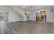 Open concept living and dining area with wood-look floors and kitchen views at 105 James Pond Ct, Debary, FL 32713