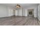 Spacious living room featuring hardwood floors and multiple doors leading to other rooms at 105 James Pond Ct, Debary, FL 32713