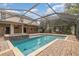 Inviting screened pool with spa and brick pavers at 105 James Pond Ct, Debary, FL 32713
