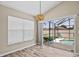 Bright dining area with backyard pool view through large sliding glass door and view at 2977 Kokomo Loop, Haines City, FL 33844