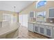 Bright kitchen featuring modern appliances, a breakfast bar, and large windows that bring in natural light at 2977 Kokomo Loop, Haines City, FL 33844