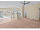 Open-concept living space with high ceilings, fan, and sliding doors to the pool area at 2977 Kokomo Loop, Haines City, FL 33844