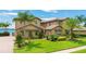 Two-story waterfront home with lush landscaping and palm trees at 4118 Isle Vista Ave, Belle Isle, FL 32812