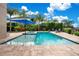 Relaxing pool and spa with a blue umbrella at 4118 Isle Vista Ave, Belle Isle, FL 32812