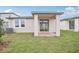 Backyard featuring a covered patio with brickwork and sliding glass doors, perfect for outdoor relaxation at 507 Kennedy Dr, Lake Alfred, FL 33850