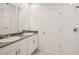 This bathroom features a double vanity with granite countertops, a mirror, and a walk-in shower at 507 Kennedy Dr, Lake Alfred, FL 33850