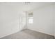 Bedroom features neutral carpet, light-colored walls, and a window at 507 Kennedy Dr, Lake Alfred, FL 33850