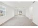 Bright and airy living room with neutral carpet, large windows, and sliding glass doors to the backyard at 507 Kennedy Dr, Lake Alfred, FL 33850