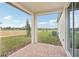 Covered patio with brick pavers and a view of the backyard at 507 Kennedy Dr, Lake Alfred, FL 33850