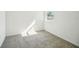 Neutral bedroom featuring gray carpet, white walls, and a window at 510 Kennedy Dr, Lake Alfred, FL 33850