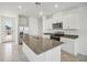 Bright kitchen features granite countertops, stainless steel appliances, and white cabinetry at 510 Kennedy Dr, Lake Alfred, FL 33850