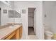 Bright bathroom featuring a single sink vanity, tile floors, and a walk-in closet at 16608 Rising Star Dr, Clermont, FL 34714
