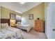 Comfortable bedroom with two twin beds, a closet, and a dresser with neutral decor at 16608 Rising Star Dr, Clermont, FL 34714