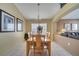 Cozy dining room with a wooden table, seating for six and tiled flooring at 16608 Rising Star Dr, Clermont, FL 34714