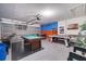 Spacious garage with game tables including a pool table, foosball and ping pong, perfect for entertainment at 16608 Rising Star Dr, Clermont, FL 34714