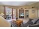 Comfortable living room with neutral tones, tiled floors, and access to outdoor pool at 16608 Rising Star Dr, Clermont, FL 34714