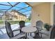 Relaxing screened patio with comfortable seating, overlooking the backyard pool and outdoor space at 16608 Rising Star Dr, Clermont, FL 34714
