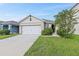 One-story home with a two-car garage and well-manicured lawn at 2321 Tay Wes Dr, Saint Cloud, FL 34771