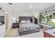 Main bedroom with a gray upholstered bed and window seat at 2321 Tay Wes Dr, Saint Cloud, FL 34771