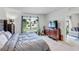 Main bedroom with gray upholstered bed, dresser, and TV at 2321 Tay Wes Dr, Saint Cloud, FL 34771