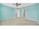 Bedroom features neutral carpet and a window, with a view into the kitchen and hallway at 687 Irvine Ranch Rd, Kissimmee, FL 34759