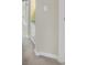 Hallway shows doorway into bathroom with glass shower door and white baseboards at 687 Irvine Ranch Rd, Kissimmee, FL 34759