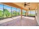 Spacious screened lanai with brick pavers, ceiling fans, and views of the backyard at 687 Irvine Ranch Rd, Kissimmee, FL 34759