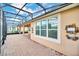 Spacious screened lanai with brick pavers and backyard views at 687 Irvine Ranch Rd, Kissimmee, FL 34759