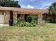 Front entrance showcasing stone pillars and a pergola feature above a garden bed at 1414 Serissa Ct, Orlando, FL 32818