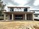 Rear view of two-story house under construction, showcasing a covered patio at 1633 Illinois St, Orlando, FL 32803