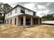 Unfinished two-story home with covered patio and large windows at 1633 Illinois St, Orlando, FL 32803