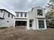 Modern two-story home with an attached two car garage and black trimmed windows at 1633 Illinois St, Orlando, FL 32803