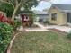 Landscaped backyard featuring a red shed, brick pathway, and well-manicured lawn at 331 Douglas Dr, Eustis, FL 32726