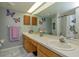 Bathroom with dual vanity, butterfly decor, and a shower with a curtain at 331 Douglas Dr, Eustis, FL 32726