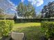 Well-maintained backyard featuring lush green grass and a manicured hedge at 9238 Kensington Row Ct, Orlando, FL 32827