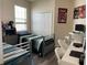 The cozy bedroom features two beds, a closet, and a well-lit desk area perfect for studying or hobbies at 9238 Kensington Row Ct, Orlando, FL 32827